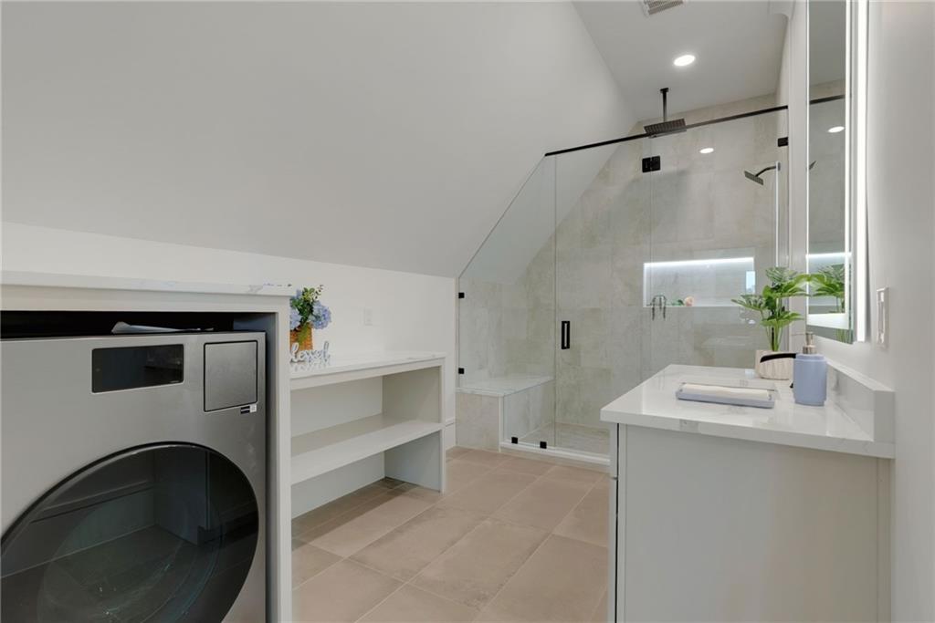 2366 Wall Road Monroe, GA 30656 - Photo 152 of 186 a bathroom with a sink a washer and dryer