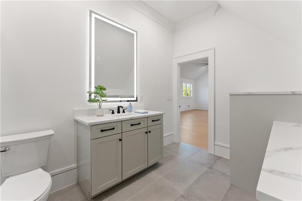 2366 Wall Road Monroe, GA 30656 - Photo 33 of 186 a bathroom with a toilet a sink a vanity and mirror