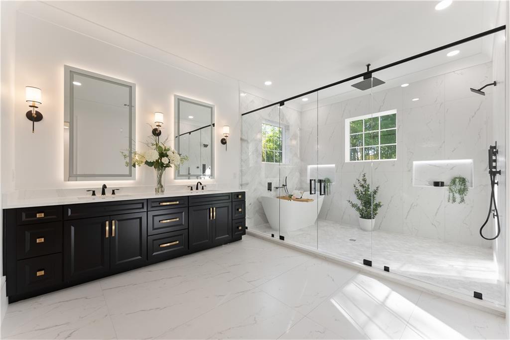 2366 Wall Road Monroe, GA 30656 - Photo 5 of 186 a spacious bathroom with a double vanity sink a large mirror and a bathtub