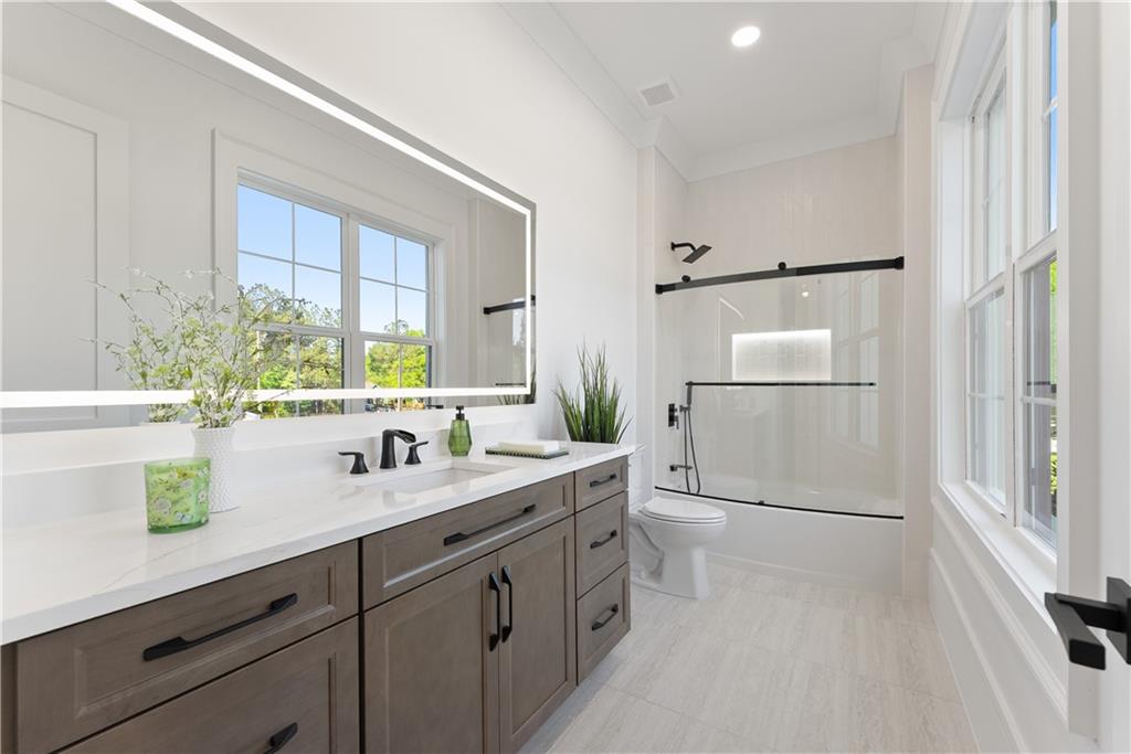 2366 Wall Road Monroe, GA 30656 - Photo 54 of 186 a spacious bathroom with a double vanity sink a mirror and shower