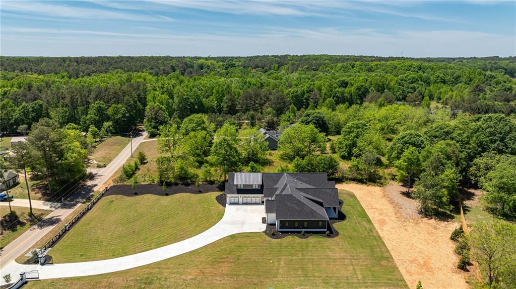 2366 Wall Road Monroe, GA 30656 - Photo 73 of 186 a view of a swimming pool with lawn chairs and plants
