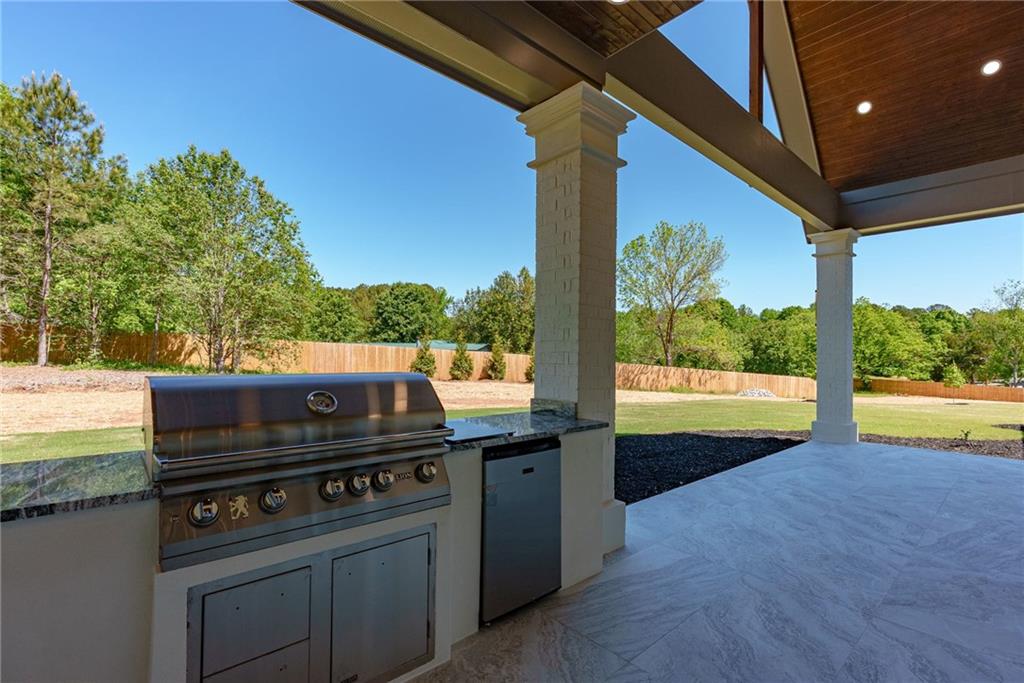 2366 Wall Road Monroe, GA 30656 - Photo 98 of 186 a view of a outdoor kitchen with a stove and sitting area