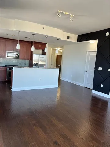 a view of kitchen and kitchen with furniture and wooden floor