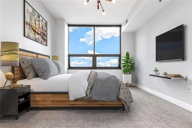 a living room with a balcony furniture and a flat screen tv