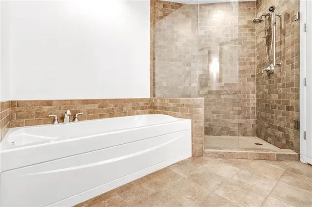 a spacious bathroom with a bathtub and shower