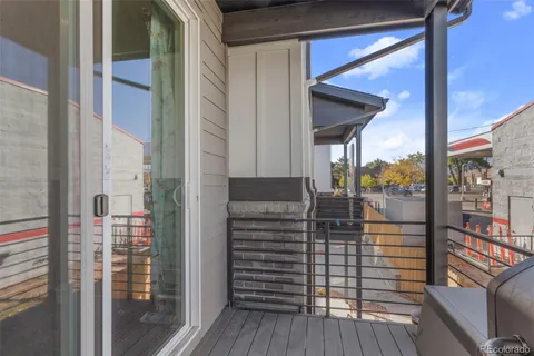 a view of staircase with railing and white walls