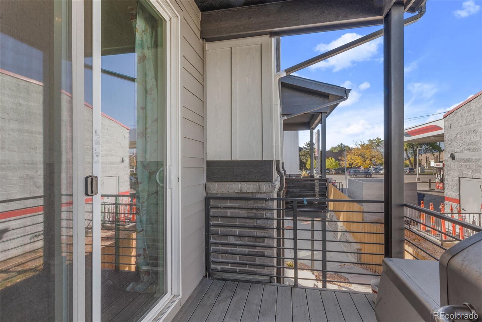 5173 Vivian Street Wheat Ridge, CO 80033 - Photo 21 of 31 a view of a balcony with floor to ceiling windows with wooden floor