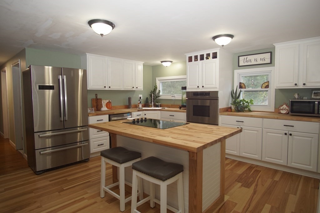 40 Marble Road Sutton, MA 01590 - Photo 3 of 16 a kitchen with a refrigerator a stove microwave and sink