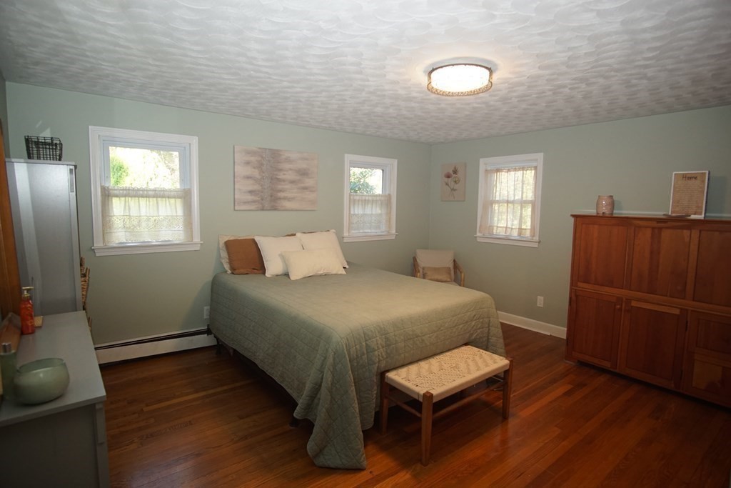 40 Marble Road Sutton, MA 01590 - Photo 6 of 16 a bedroom with a bed and wooden floor