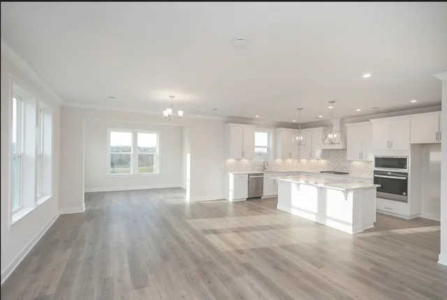 a view of kitchen with wooden floor and windows