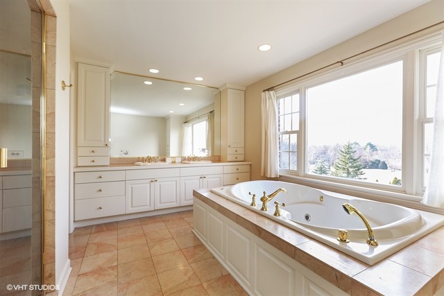 6040 South Grant Street Burr Ridge, IL 60527 - Photo 14 of 25 a spacious bathroom with a granite countertop tub and a sink