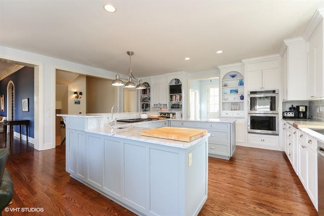 6040 South Grant Street Burr Ridge, IL 60527 - Photo 3 of 25 a large kitchen with stainless steel appliances kitchen island granite countertop a large counter top and view living room