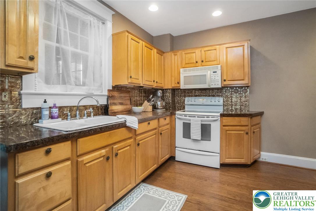 1209 Maple Street Bethlehem, PA 18018 - Photo 20 of 46 a kitchen with stainless steel appliances granite countertop a sink and a stove