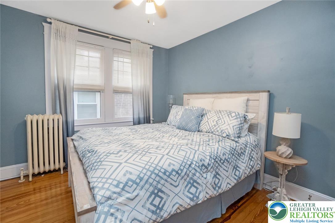 1209 Maple Street Bethlehem, PA 18018 - Photo 24 of 46 a bedroom with a bed and a chandelier