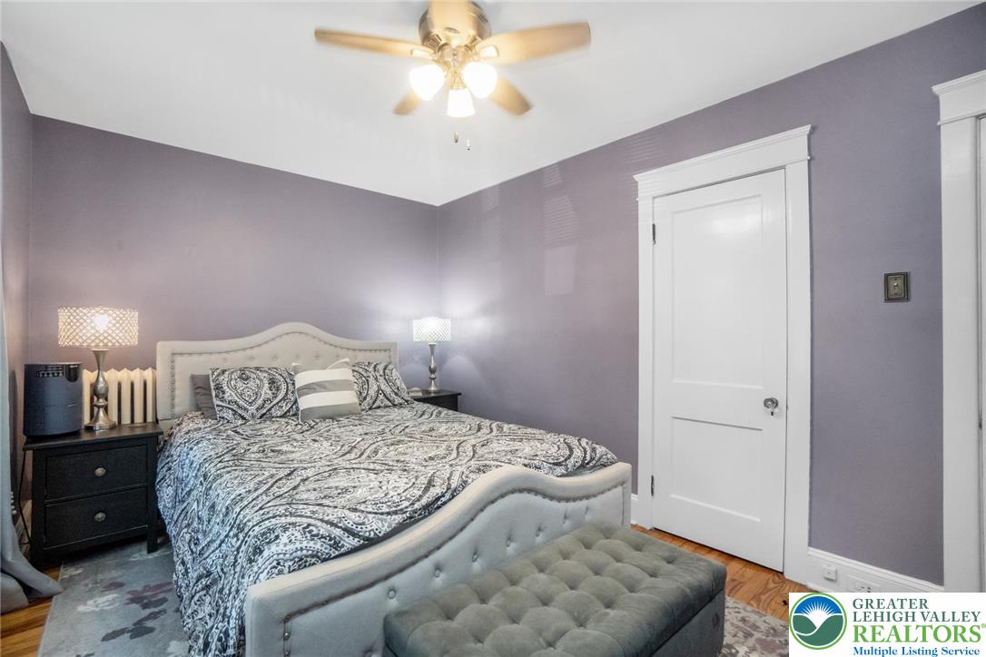 1209 Maple Street Bethlehem, PA 18018 - Photo 27 of 46 a bedroom with a bed and a chandelier