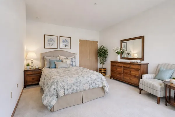 a bedroom with a bed and a couch