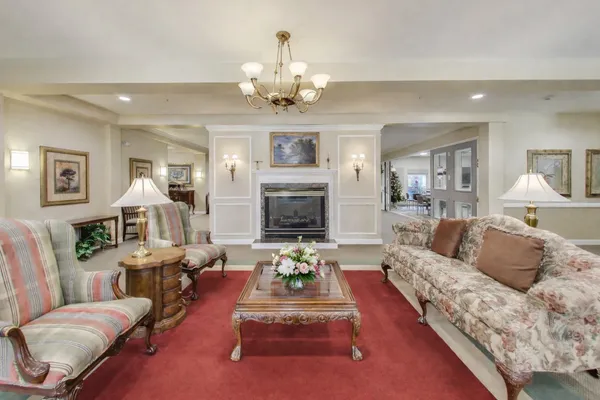 a living room with furniture and a chandelier