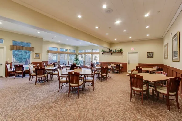a living room with lots of furniture and a large window