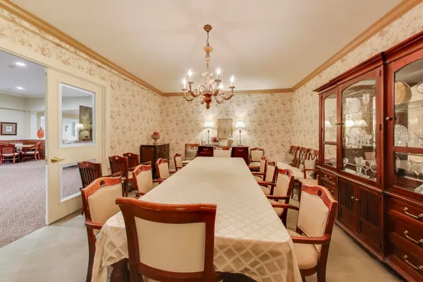 a very nice looking dining room with a large dining table and a large window with the garden view