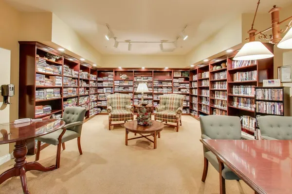 a reading room with furniture and book shelf