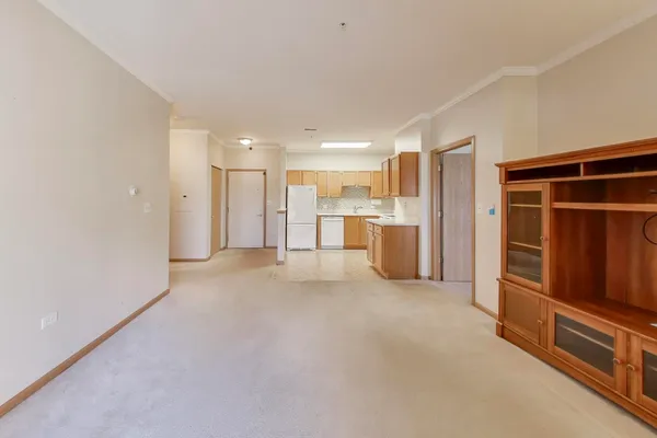 a view of kitchen with refrigerator and window