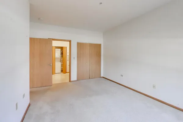 a view of an empty room and a window