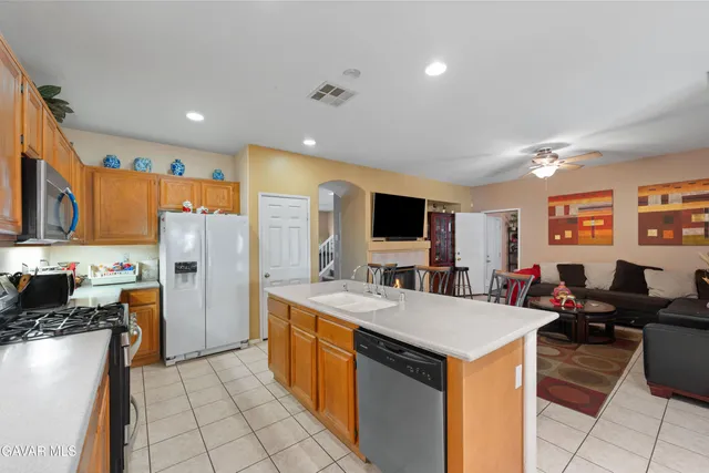 a large kitchen with a large counter top appliances and cabinets
