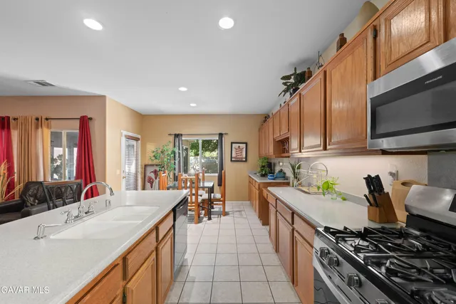 a kitchen with sink stove and cabinets
