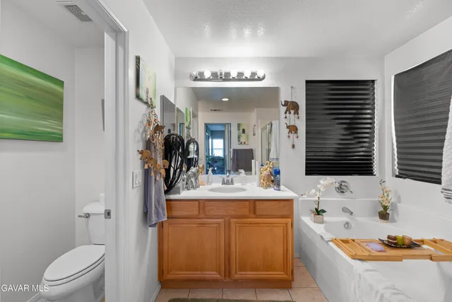 a bathroom with a bathtub a sink and a large mirror