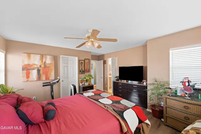 a bedroom with a bed and flat screen tv