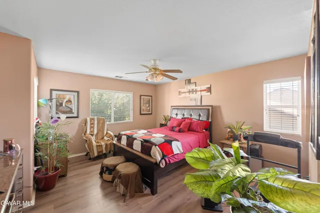 a bedroom with furniture and a large window