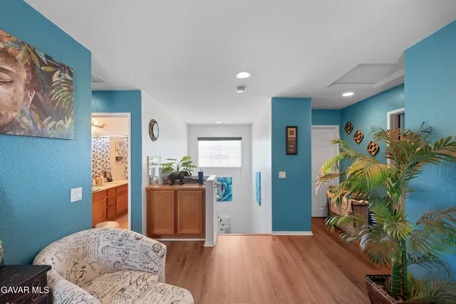 a living room with furniture and a potted plant