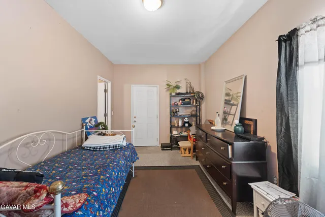 a bedroom with bed and wooden floor