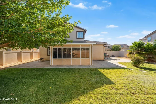 a view of a house with a swimming pool and a yard