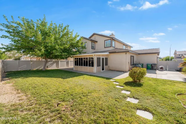 a view of a house with swimming pool and sitting area