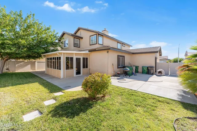 a view of a house with swimming pool and a yard