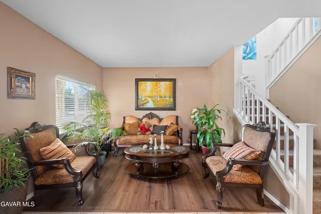 a living room with furniture and a potted plant