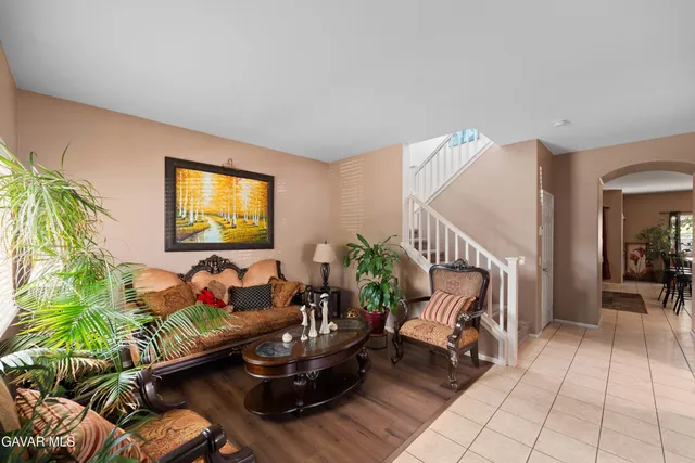 a living room with furniture and a potted plant