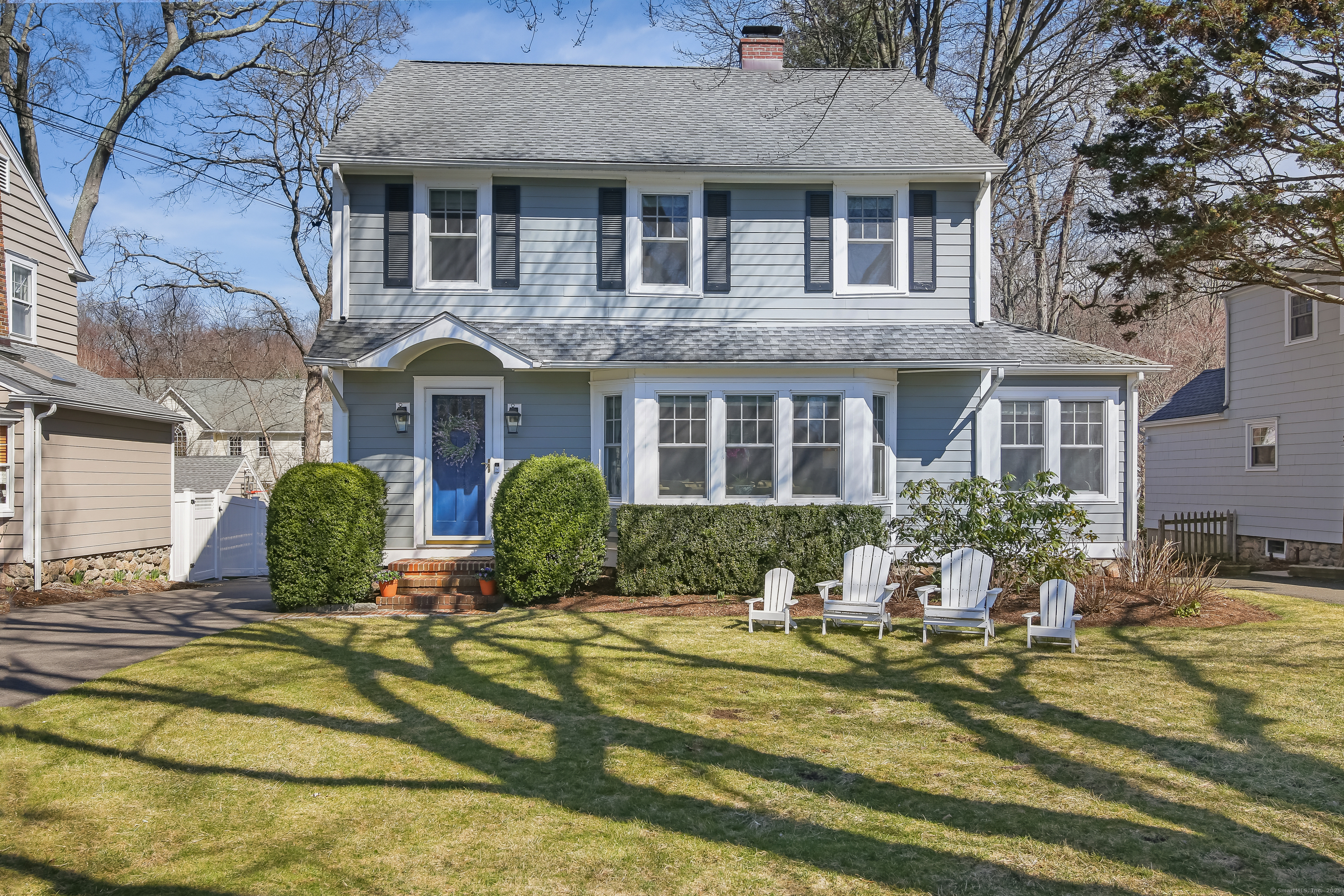a front view of a house with yard and outdoor seating