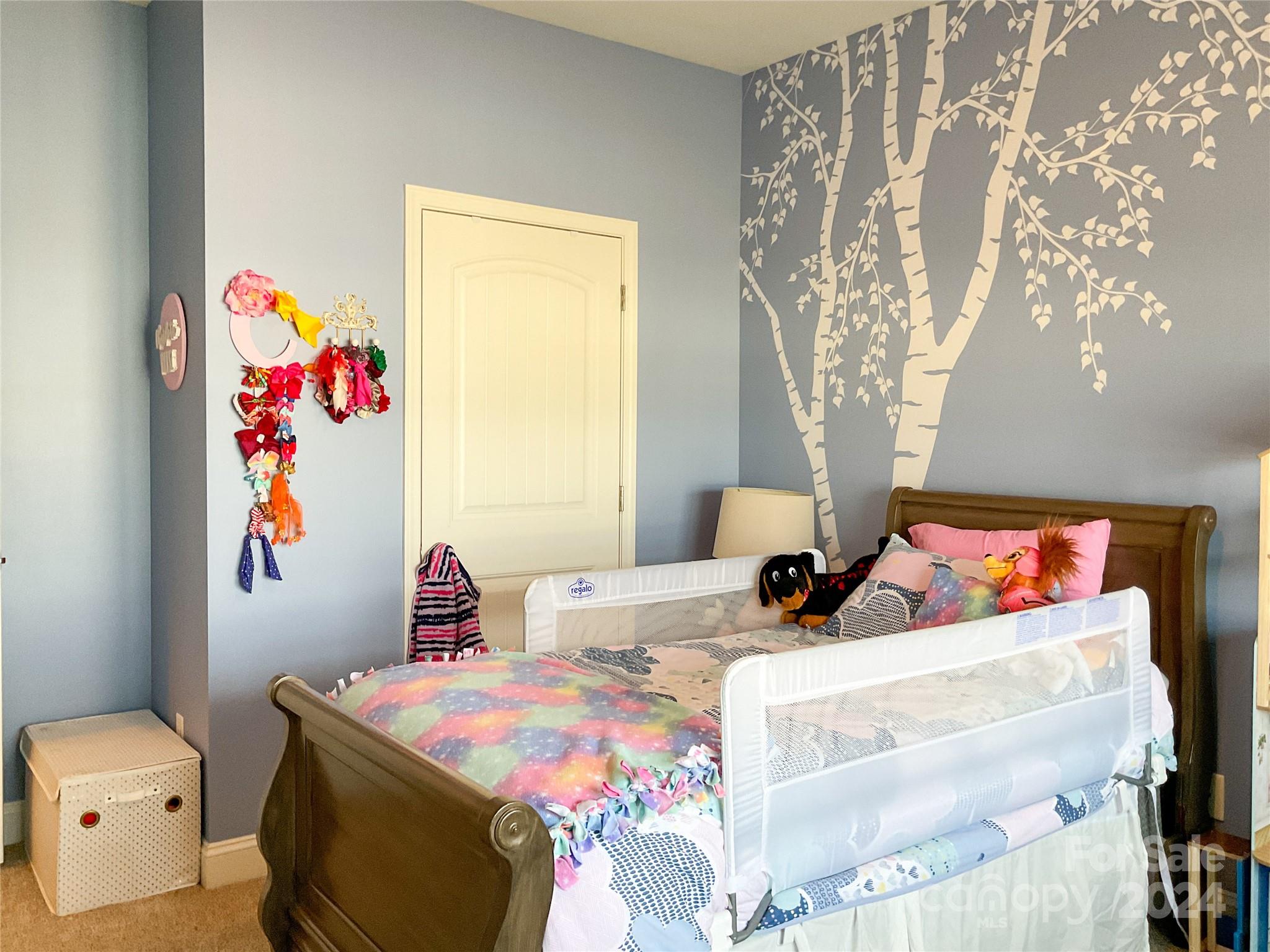 349 Intrepid Court Greer, SC 29650 - Photo 23 of 31 a bedroom with a bed and a chandelier