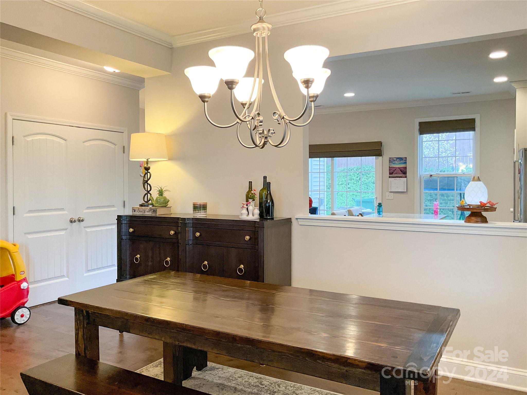 349 Intrepid Court Greer, SC 29650 - Photo 6 of 31 a room with a table chairs and wooden floor
