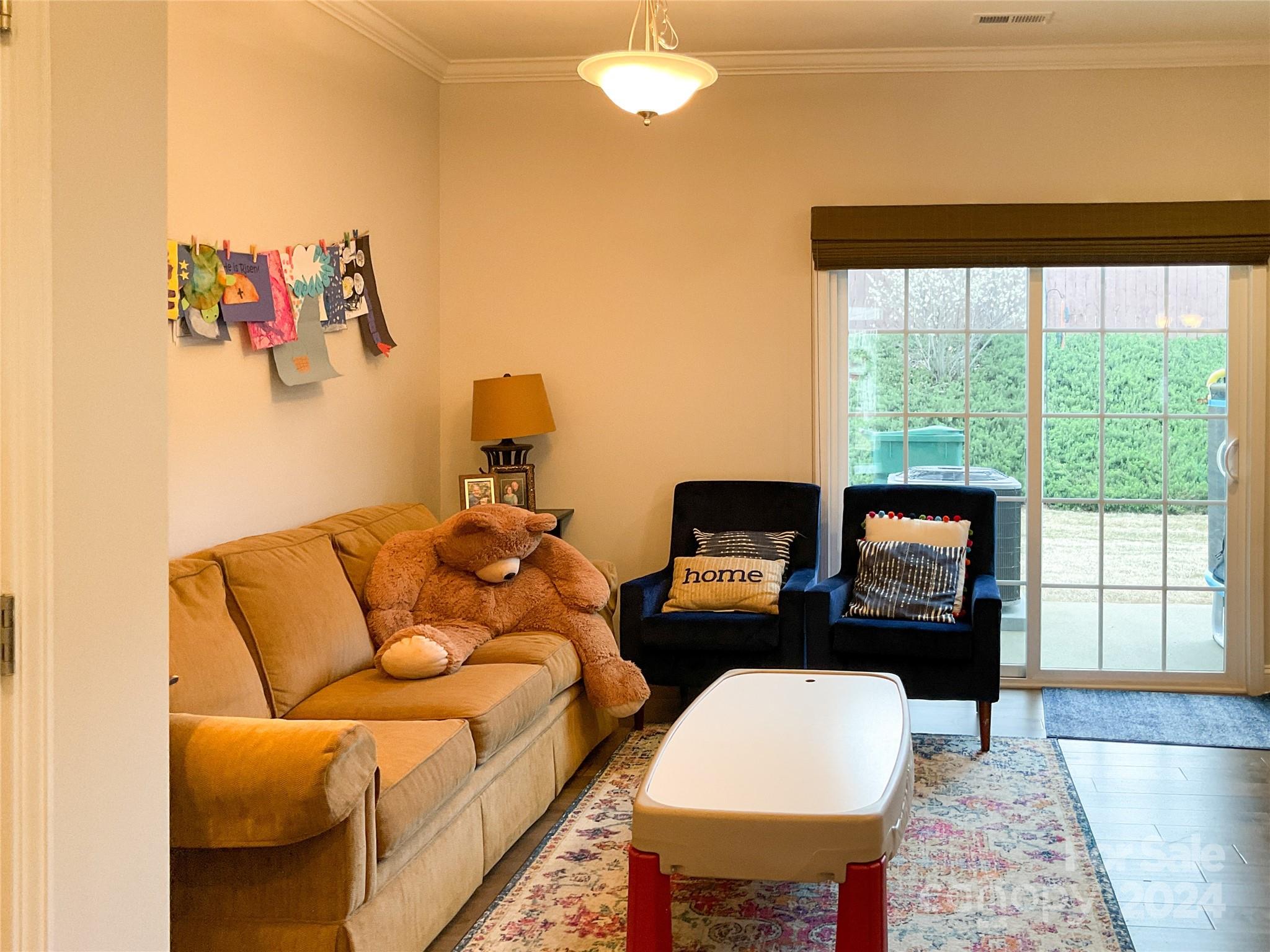 349 Intrepid Court Greer, SC 29650 - Photo 8 of 31 a living room with furniture a flat screen tv and a large window