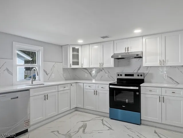 a kitchen with a sink stove and cabinets