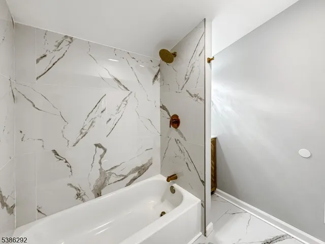 a bathroom with a bathtub and shower