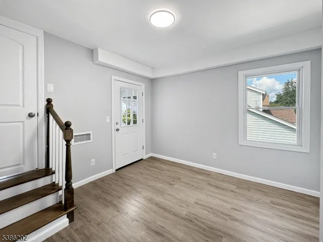 wooden floor in an empty room with a window