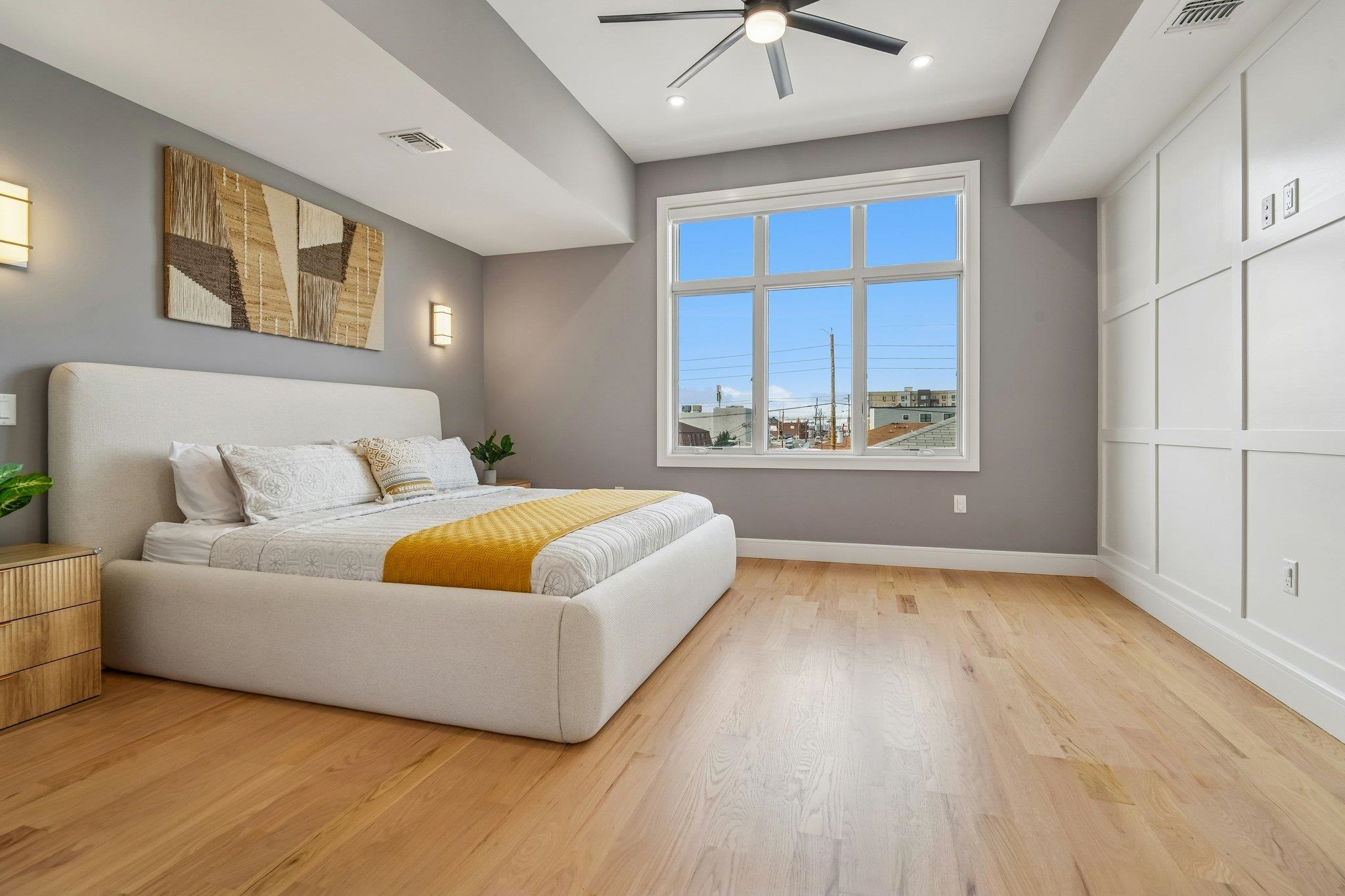 305 8th Street Fairview, NJ 07022 - Photo 18 of 27 a bedroom with a bed and a large window