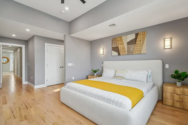 a living room with a bed furniture and next to a window