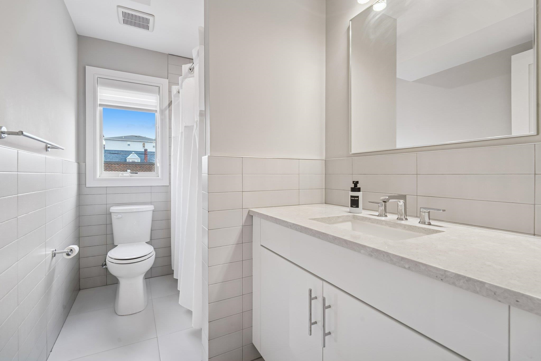 305 8th Street Fairview, NJ 07022 - Photo 20 of 27 a bathroom with a sink toilet and a mirror