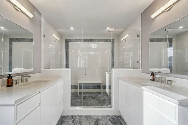 a spacious bathroom with a sink and a mirror