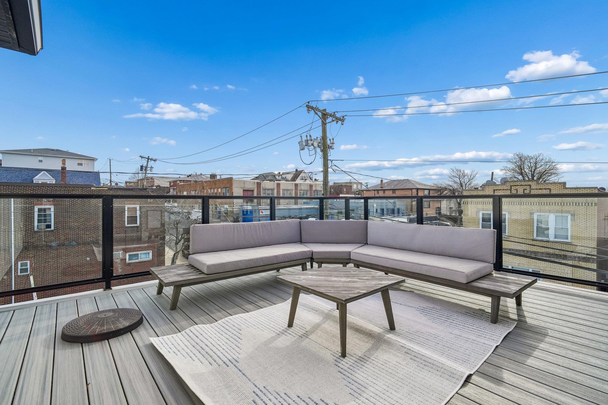 305 8th Street Fairview, NJ 07022 - Photo 27 of 27 a roof deck with couches and potted plants with sky view